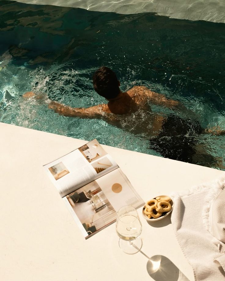 Overhead lifestyle scene of luxury poolside content and editorial details